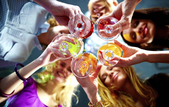 Below view of people clinking glasses with each other