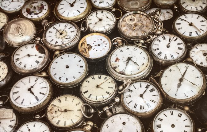 Retro styled image of old scratched and run down pocket watches